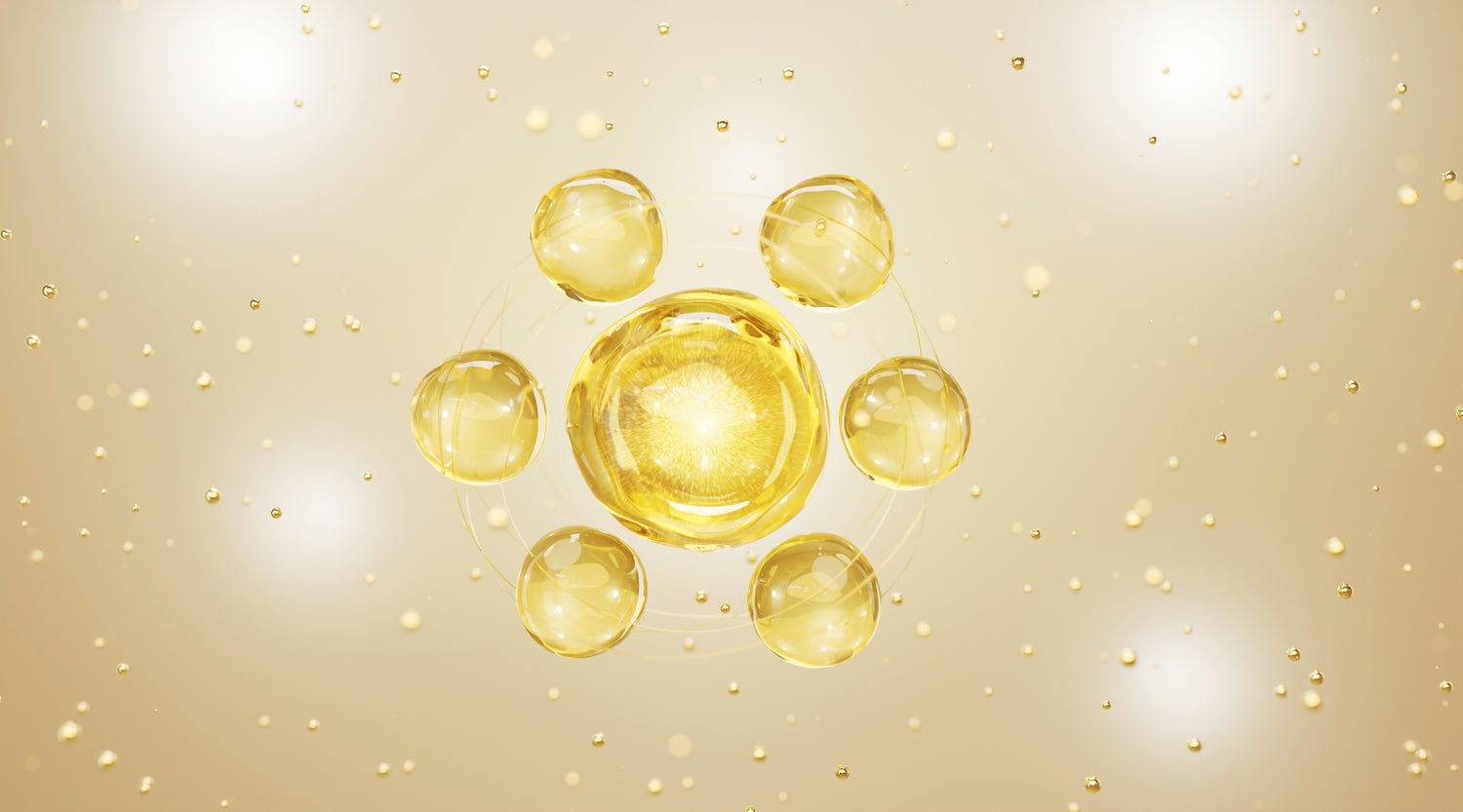 Gold droplets on a beige background