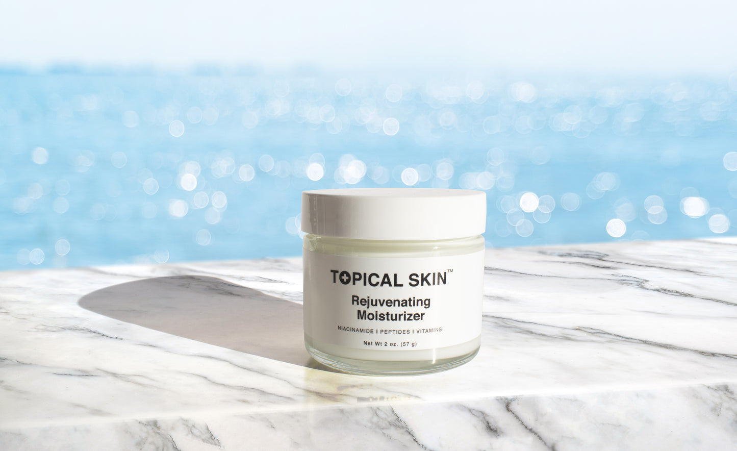 Topical Skin Rejuvenating Moisturizer with Niacinamide, Vitamins and Peptide - blue shimmering waters in the background