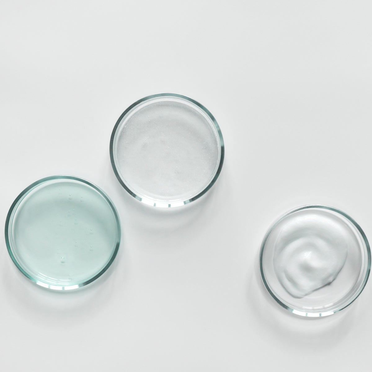 Three clear glass bowls with watery gel-like contents on a white background, viewed from above.