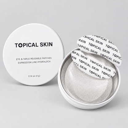 Topical Skin eye and smile reusable patches in a round clear container, with the white lid placed beside the open container showing the patches inside.